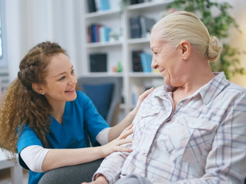 A nurse speaking to an older woman.