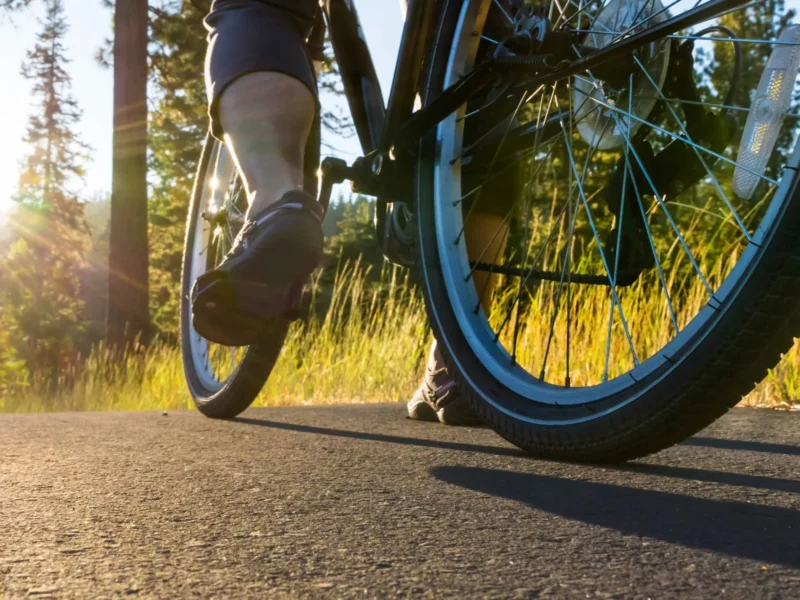 A person on a bike on a country road.