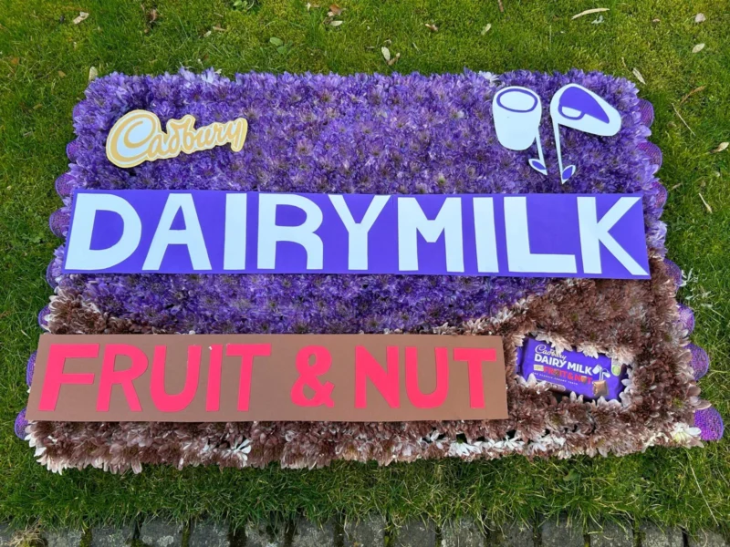 A floral arrangement resembling a Diary Milk fruit and nut bar.