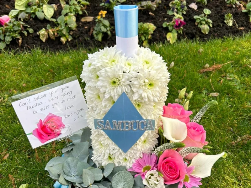 A floral arrangement resembling a bottle of Sambuca.